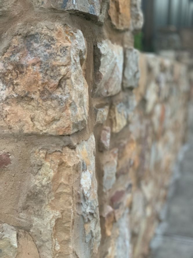 Close up photo of a beautiful rock retainign wall on the Sunshine Coast using a light sandstone coloured rock